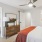 a bedroom with a bed and a mirror