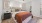 a bedroom with a bed and a fan