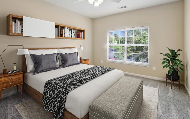 a bedroom with a bed and a fan