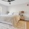 a bedroom with a bed and a fan