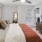 a bedroom with a bed and a fan