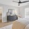 a bedroom with a bed and a fan