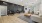 a large living room with a black wall and a black couch