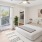 a living room with a white couch and a white table